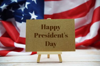 Happy President's Day text messege  with USA flag on wooden background