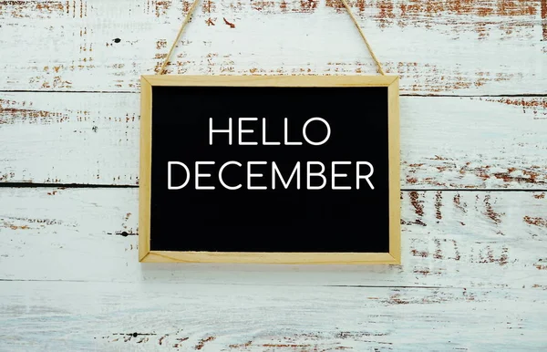 Hello December Typography Text Blackboard Hanging Wall Background — стоковое фото