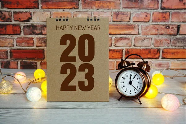 Happy New Year 2023 text message with alarm clock and LED cotton balls decoration