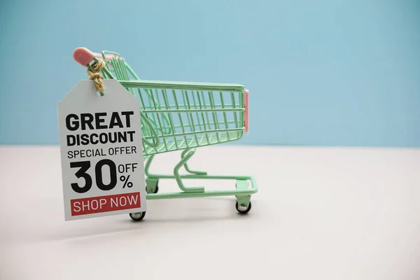 Great Discount 30% offCyber Monday Sale 50%  text message on price tax with shoppint trolley cart on blue andp pink background