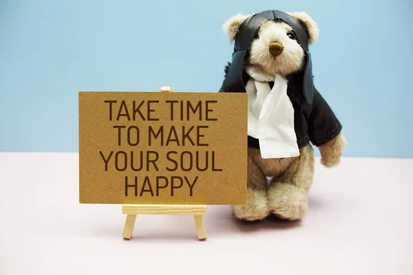 Take time to make your soul happy text message with teddy bear on blue and pink background