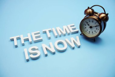 The Time is Now alphabet letters on blue background