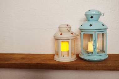 Blue and Pink lantern with LED candle light Home decoration accessories on wooden shelves