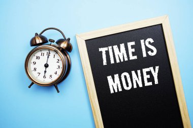 Time is Money word with alarm clock on blue background