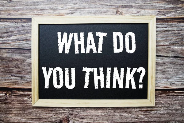 What Do You Think? word with alarm clock on wooden background