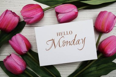 Hello Monday card with tulip flower on wooden background