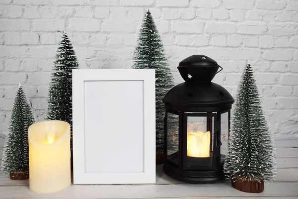 Empty mock up photo frame with LED candle light on white brick wall background