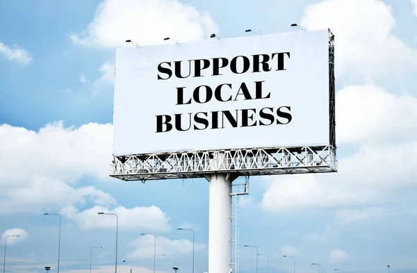 Support Local Business text message on signboard with blue sky
