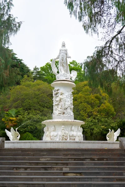 Fountain The Fairytale with sculpture of woman and swans in Sochi Arboretum, Russia