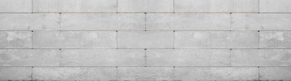 Gray retaining wall garden from concrete shuttering blocks masonry brickwork wall texture banner panorama