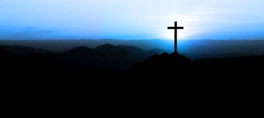 Religious grief landscape background banner panorama - Breathtaking view with black silhouette of mountains, hills, forest and cross / summit cross, in the evening during the sunset, with blue colored sky clipart