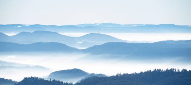 Amazing mystical rising fog mountains sky forest trees landscape view in black forest ( Schwarzwald ) winter, Germany panorama panoramic banner - mystical snow foggy mood