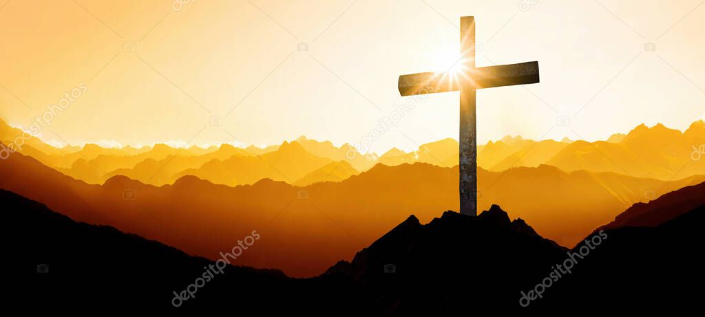 Religious grief landscape background banner panorama - View with black silhouette of mountains alps, hills, forest and cross / summit cross, in the evening during the sunset, with orange colored sky