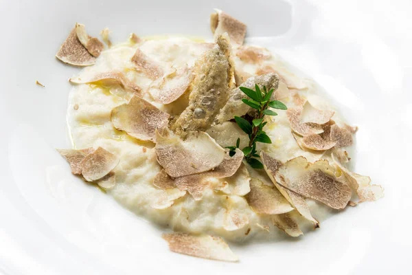 Plate with cod cream and white truffle isolated on white background
