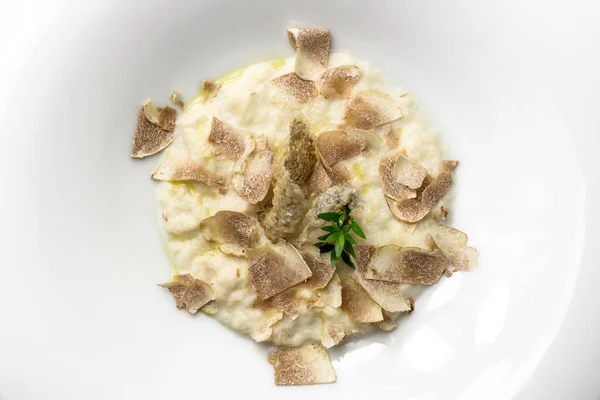 Plate with cod cream and white truffle isolated on white background