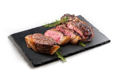Fiorentina T-bone steak cut on Rectangular plate in black slate isolated on white background