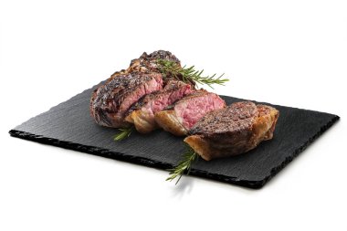 Fiorentina T-bone steak on Rectangular plate in black slate isolated on white background