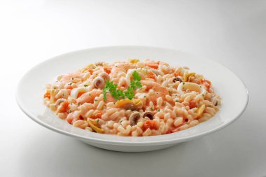 White bowl with fish and tomato risotto and parsley isolated on white background