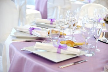 Detail of a table set in pink runner for a elegant wedding banquet