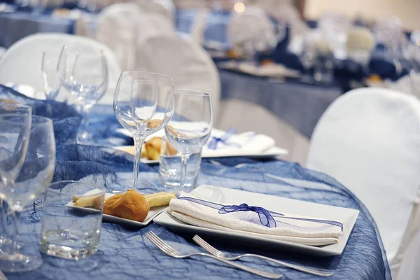 Detail of a elegant table set in blue color organza for a wedding banquet