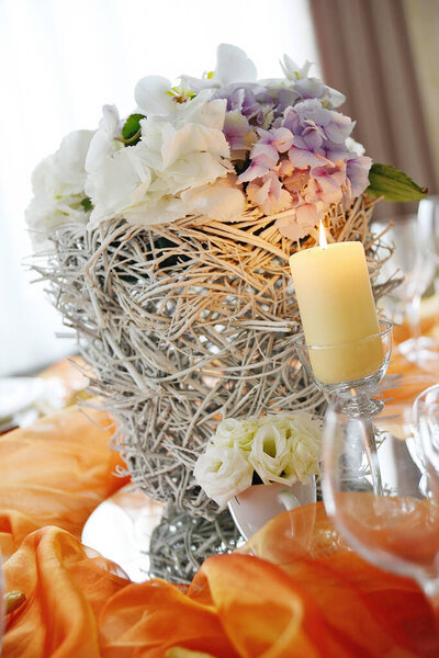 Detail of a table set in orange organza for a elegant wedding banquet