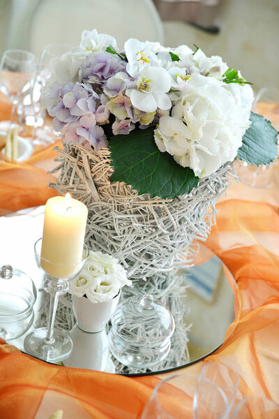 Detail of a table set in orange organza for a elegant wedding banquet