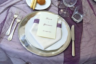 Detail of a table set in purple organza for a elegant wedding banquet