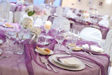 Detail of a table set in purple organza for a elegant wedding banquet