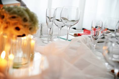 Detail of a table set in white for a wedding banquet