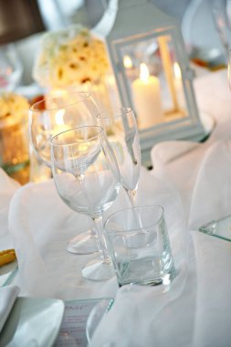 Detail of a table set in white for a wedding banquet