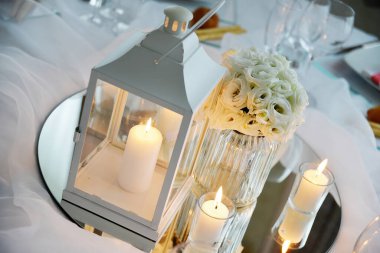Detail of a table set in white for a wedding banquet