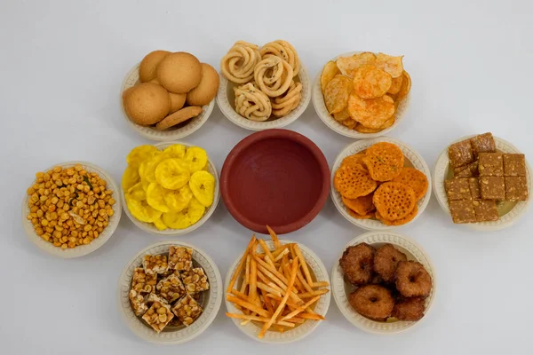 Traditional Indian Diwali salty snacks and sweets, foods items displayed and arranged in bowl on an isolated background. Tamilnadu snacks for the Diwali festival and tea time and movie time snacks