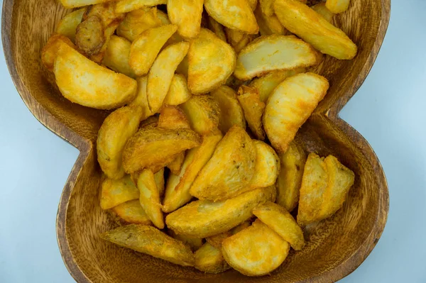 Baked potato wedges with spicy coating and deep fried - homemade organic vegetable vegan vegetarian potato wedges snack food meal. Potato wedges with a spicy Mexican coating - Paprika potato wedges fries chips in isolated white background and ready t