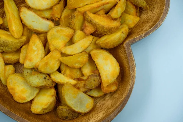 Baked potato wedges with spicy coating and deep fried - homemade organic vegetable vegan vegetarian potato wedges snack food meal. Potato wedges with a spicy Mexican coating - Paprika potato wedges fries chips in isolated white background and ready t