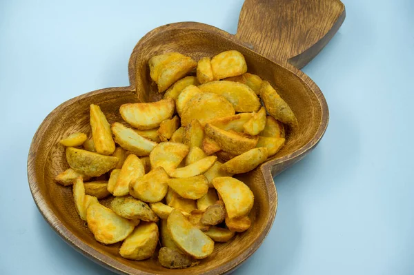 Baked potato wedges with spicy coating and deep fried - homemade organic vegetable vegan vegetarian potato wedges snack food meal. Potato wedges with a spicy Mexican coating - Paprika potato wedges fries chips in isolated white background and ready t