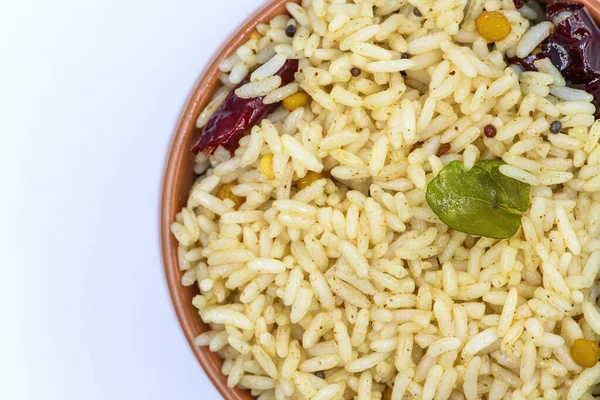 Selective focused ,Tamarind Rice/  Puliyodharai / Puliyogare - Tangy and spicy South Indian rice dish as break fast , Lunch or dinner isolated in white background. Tamarind as main ingredient and other spices. Famous Tamilnadu dish