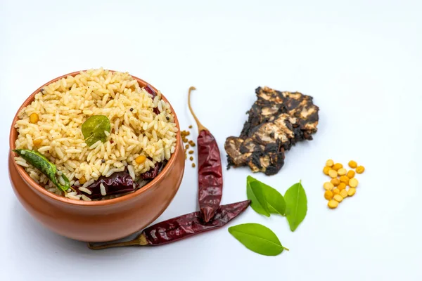 Selective focused ,Tamarind Rice/  Puliyodharai / Puliyogare - Tangy and spicy South Indian rice dish as break fast , Lunch or dinner isolated in white background. Tamarind as main ingredient and other spices. Famous Tamilnadu dish