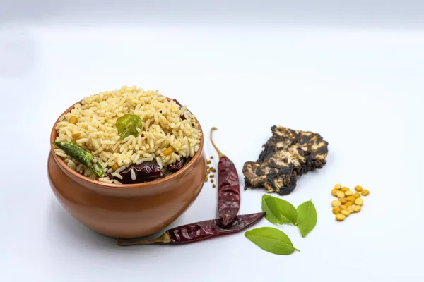 Selective focused ,Tamarind Rice/  Puliyodharai / Puliyogare - Tangy and spicy South Indian rice dish as break fast , Lunch or dinner isolated in white background. Tamarind as main ingredient and other spices. Famous Tamilnadu dish