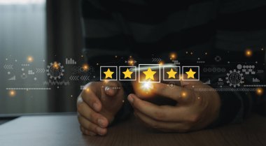 Close up man using mobile phone for rating feedback from customer service with annual survey with five gold star icon. Business annual satisfaction survey concept. User reviews and feedback online.