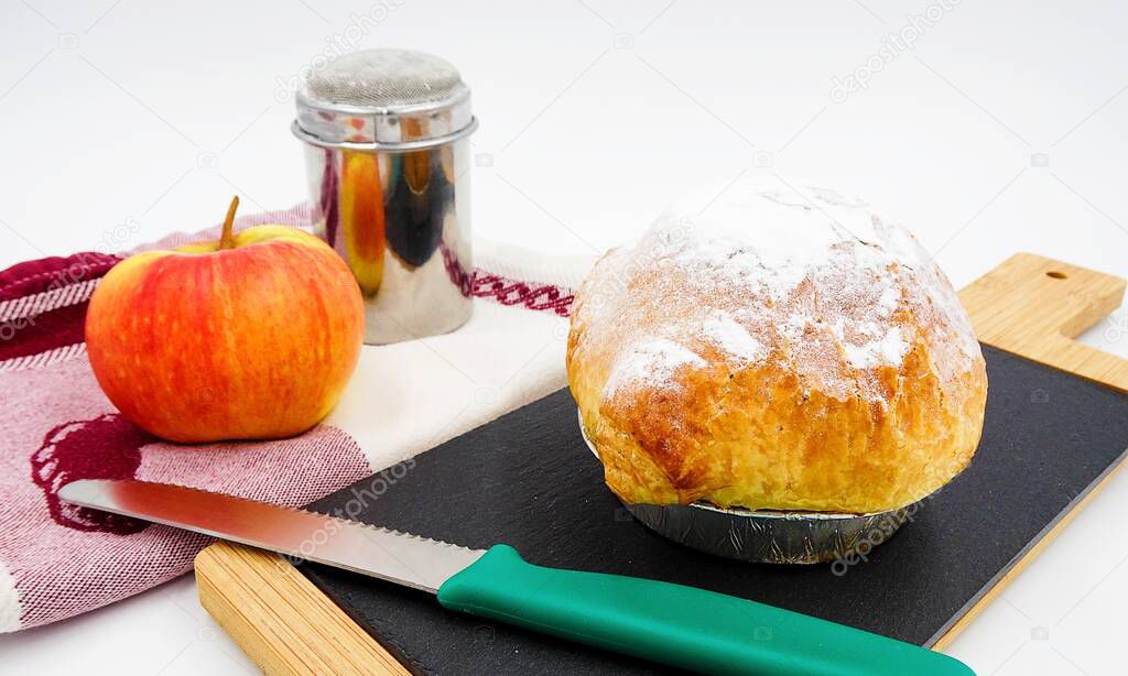  Apple dumpling, apple, towel, cutting board and knife.