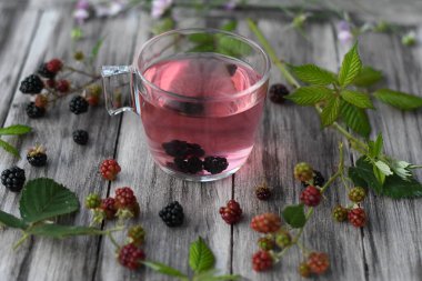 raspberry juice with fresh berries on wooden background