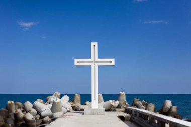 white cross by the sea