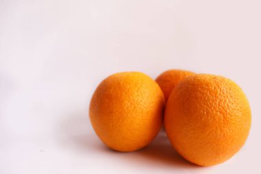 3 Big sweet oranges known as Citrus sp or Sunkist Oranges in the isolated white background