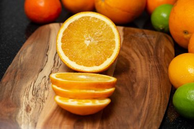 Fresh orange, cut into slices on a cutting board