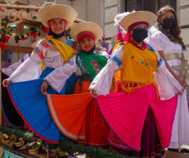 cuenca, Ecuador, Dec 24, 2021 - Women n costume pose for camera in the traditional Traveling Child Pase del Nino Christmas Eve Parade