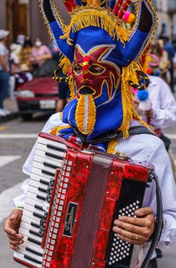 cuenca, Ecuador, Dec 24, 2021 - Man plays accordion in the traditional Traveling Child Pase del Nino Christmas Eve Parade