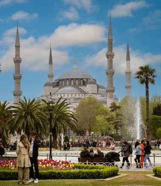 Istanbul, Turkey - April 29, 2022 - Tourists wander on the grounds of a Mosque. High quality photo