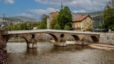 Sarajevo, Bosnia - May 2, 2022 - Library building was the City Hall before The War, and the Latin Bridge.
