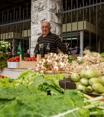 Montenegro - May 7, 2022 - Man sells fruits and vegetables at a stall in the market.
