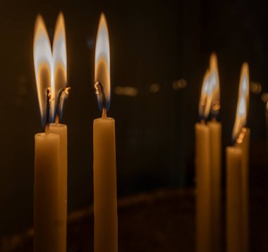 Albania, May 12, 2022 - candle flames burning in a church.